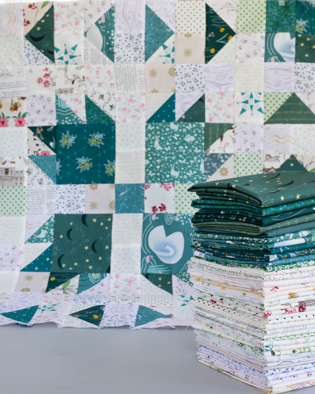 teal quit block with teal fat quarter bundle stack