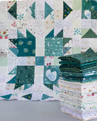 teal quit block with teal fat quarter bundle stack